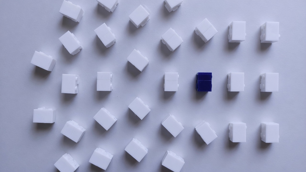 Scattered identical small white blocks with one indigo block aligned
