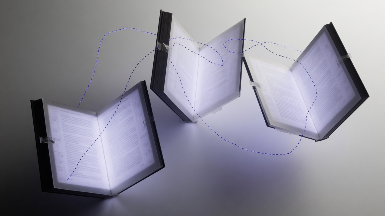 Separate page slabs of light linked by thin indigo traces