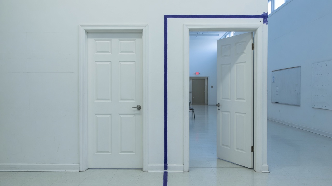 Two nearly identical white doorways with a slight misalignment and an indigo divider